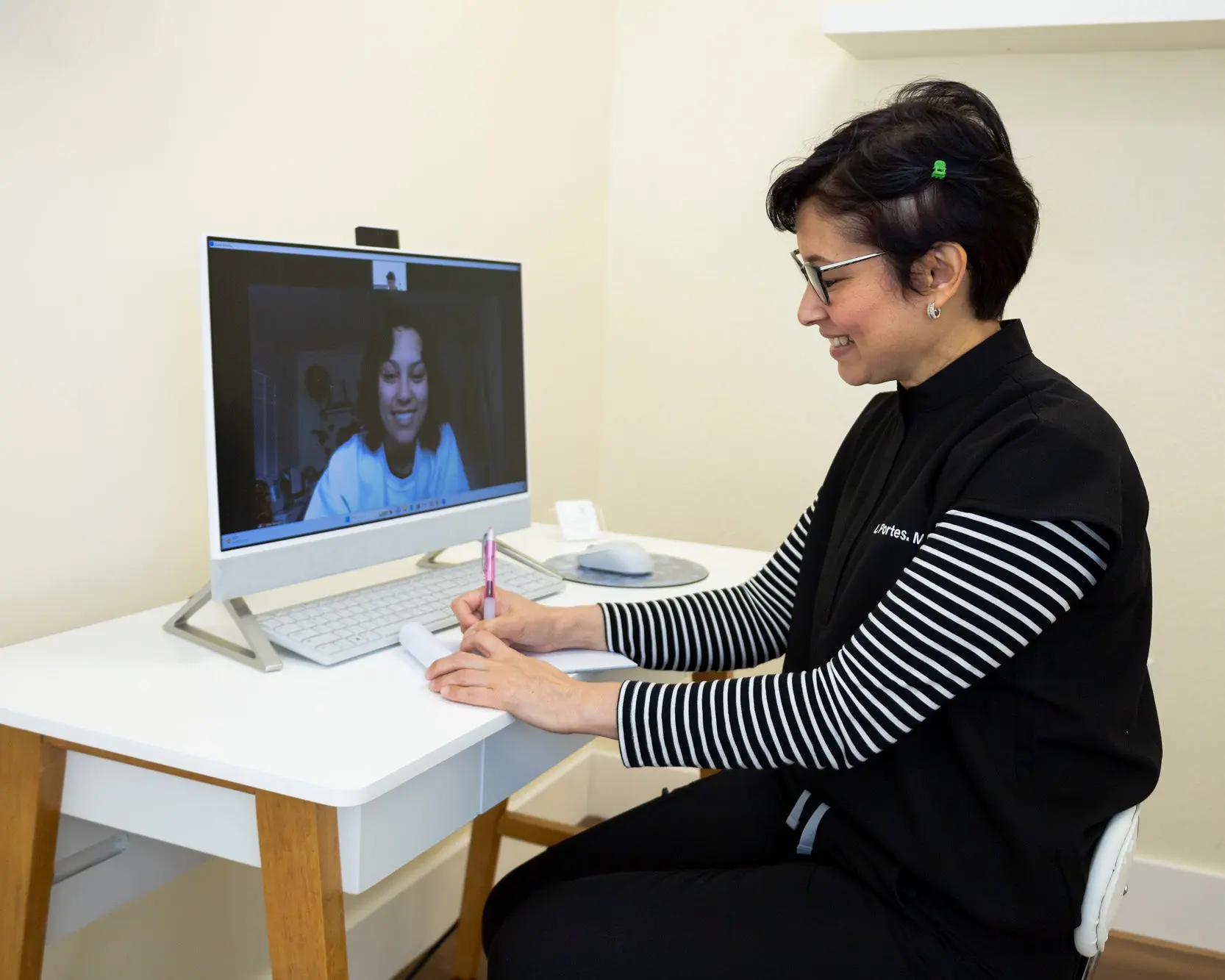 Dr. Lisette Portes smiling during a virtual visit with a patient